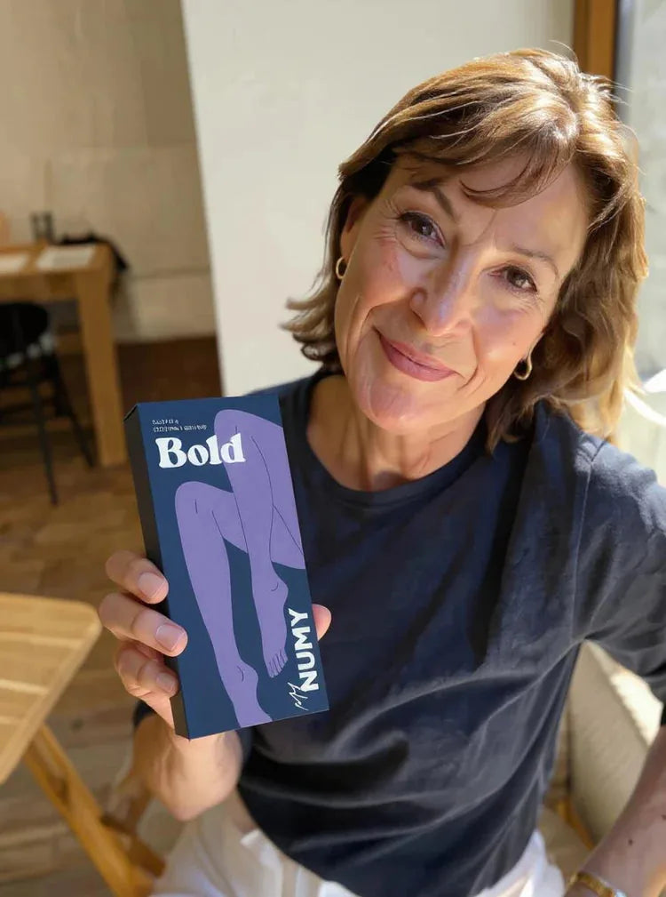 A NUMY customer holding her Bold box